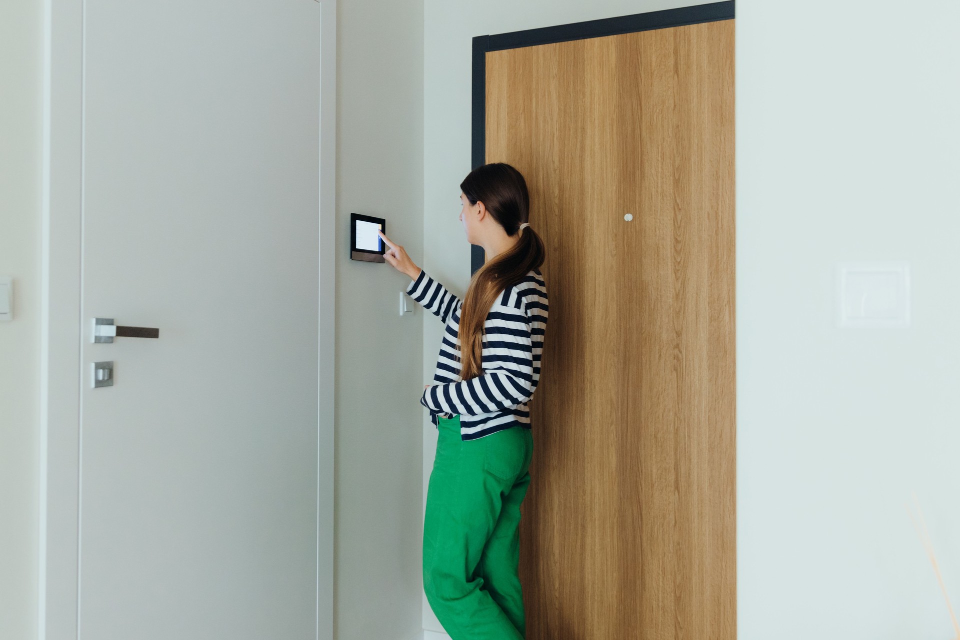 Woman Using Smart Home Devise at Her Modern Apartment